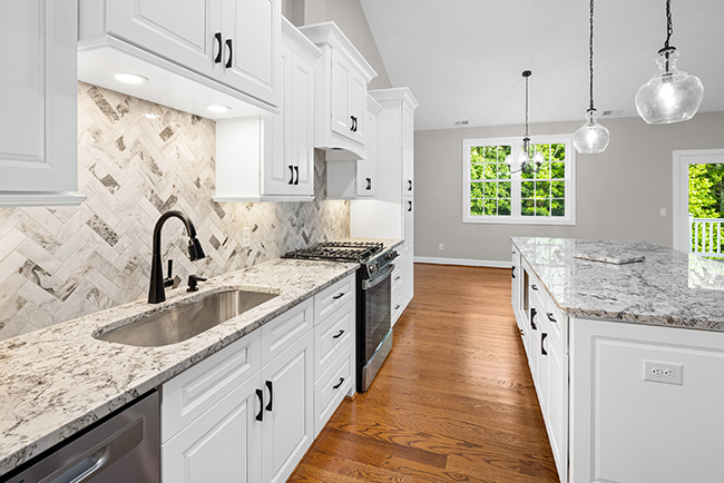 photo of kitchen with granite countertops & hardwood floors in a luxury townhome